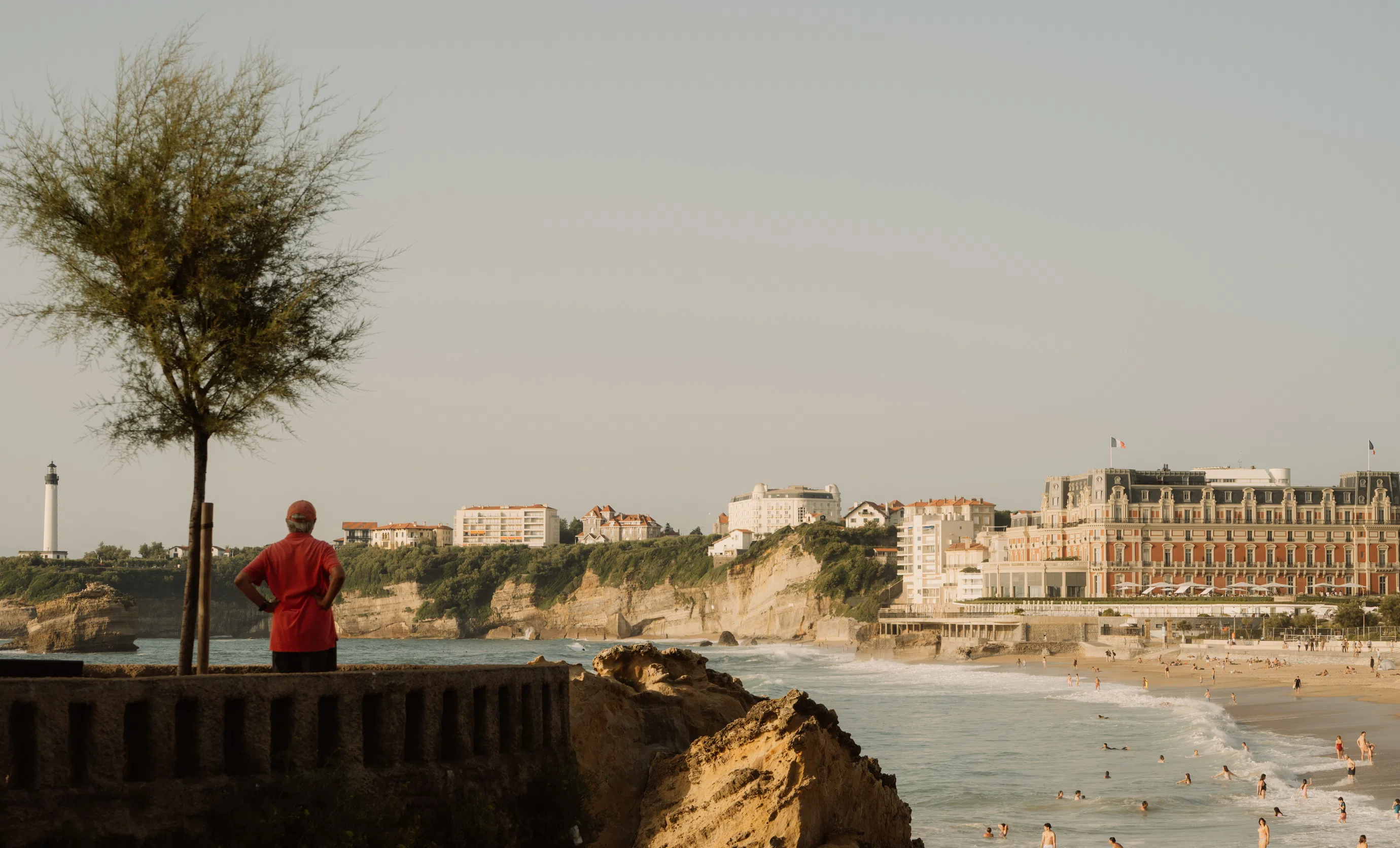 Scenic view of the coastline, sandy beach, and historic hotel architecture in Biarritz near Hôtel Le Garage.