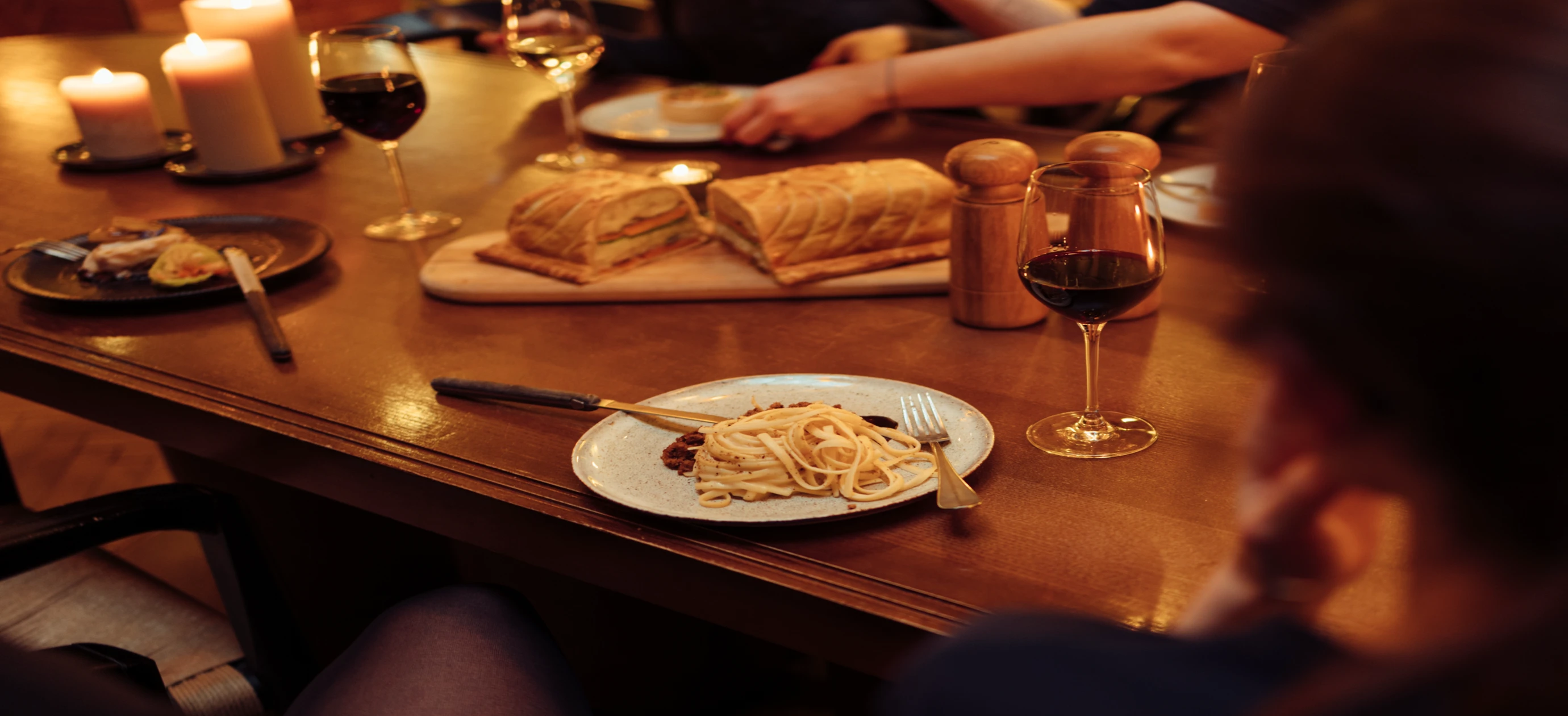 Convivial dinner with friends, pasta dishes, and wine in a refined restaurant, Experimental Group.