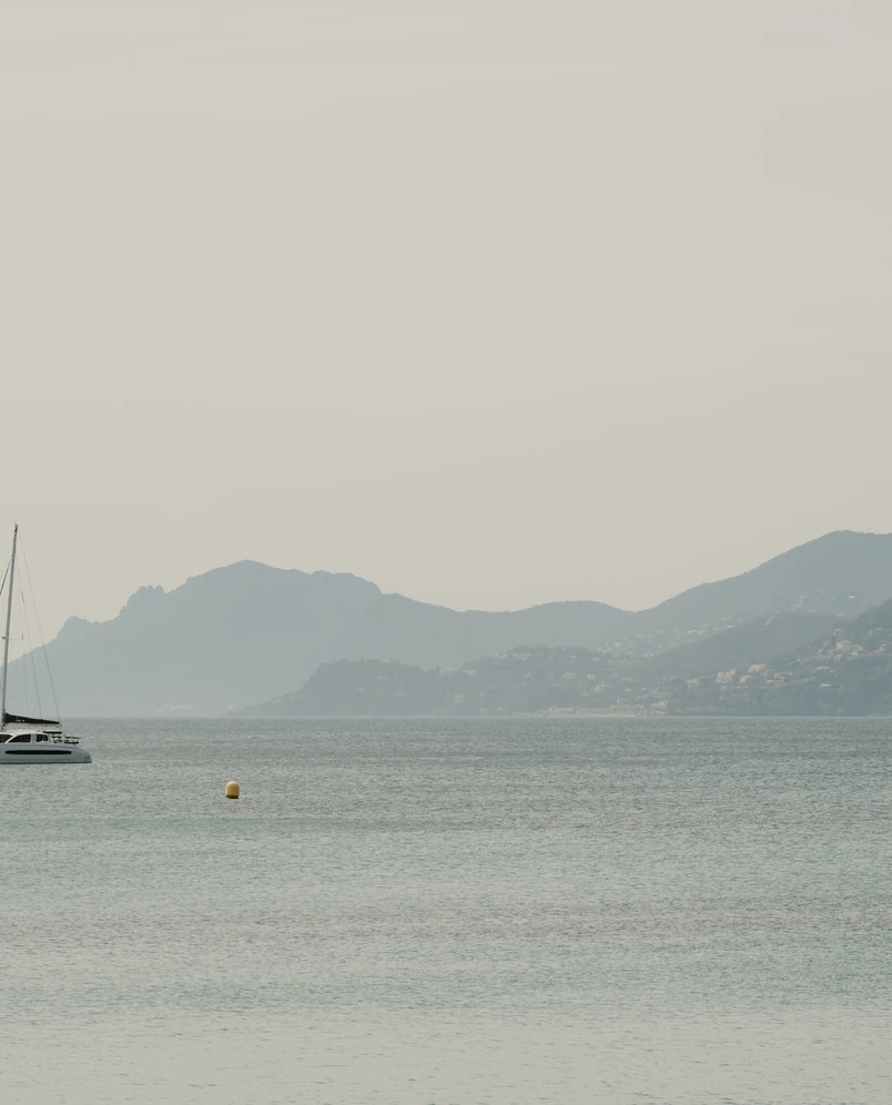 Panoramic view of a catamaran off a mountainous coast, Experimental Group.