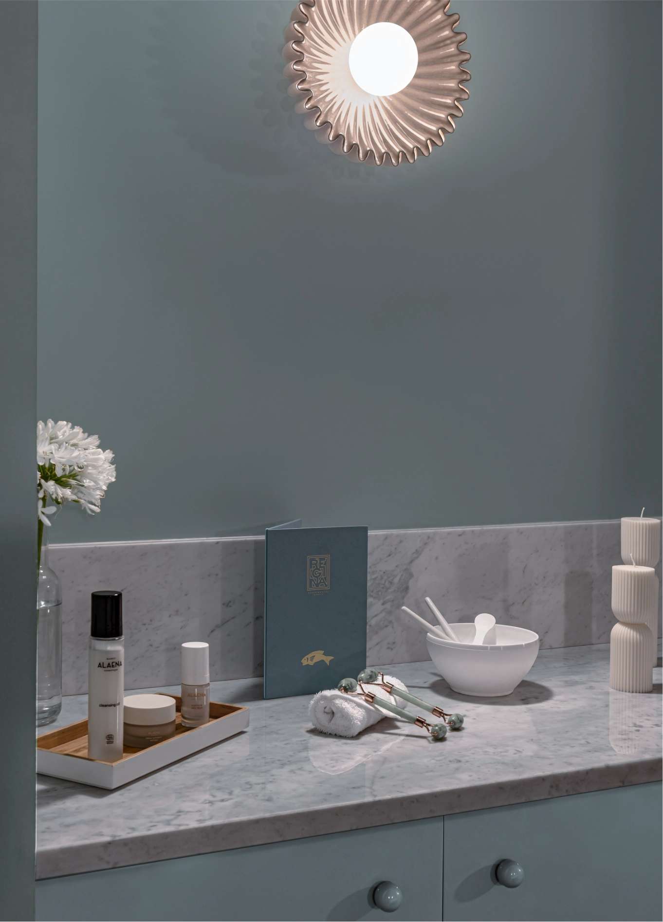 Details of skincare products and elegant accessories placed on the spa counter at Regina Experimental.