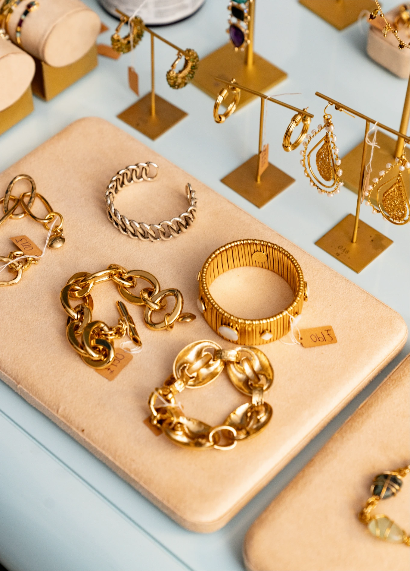 Gold jewellery and accessories displayed at Cowley Manor boutique, Cotswolds