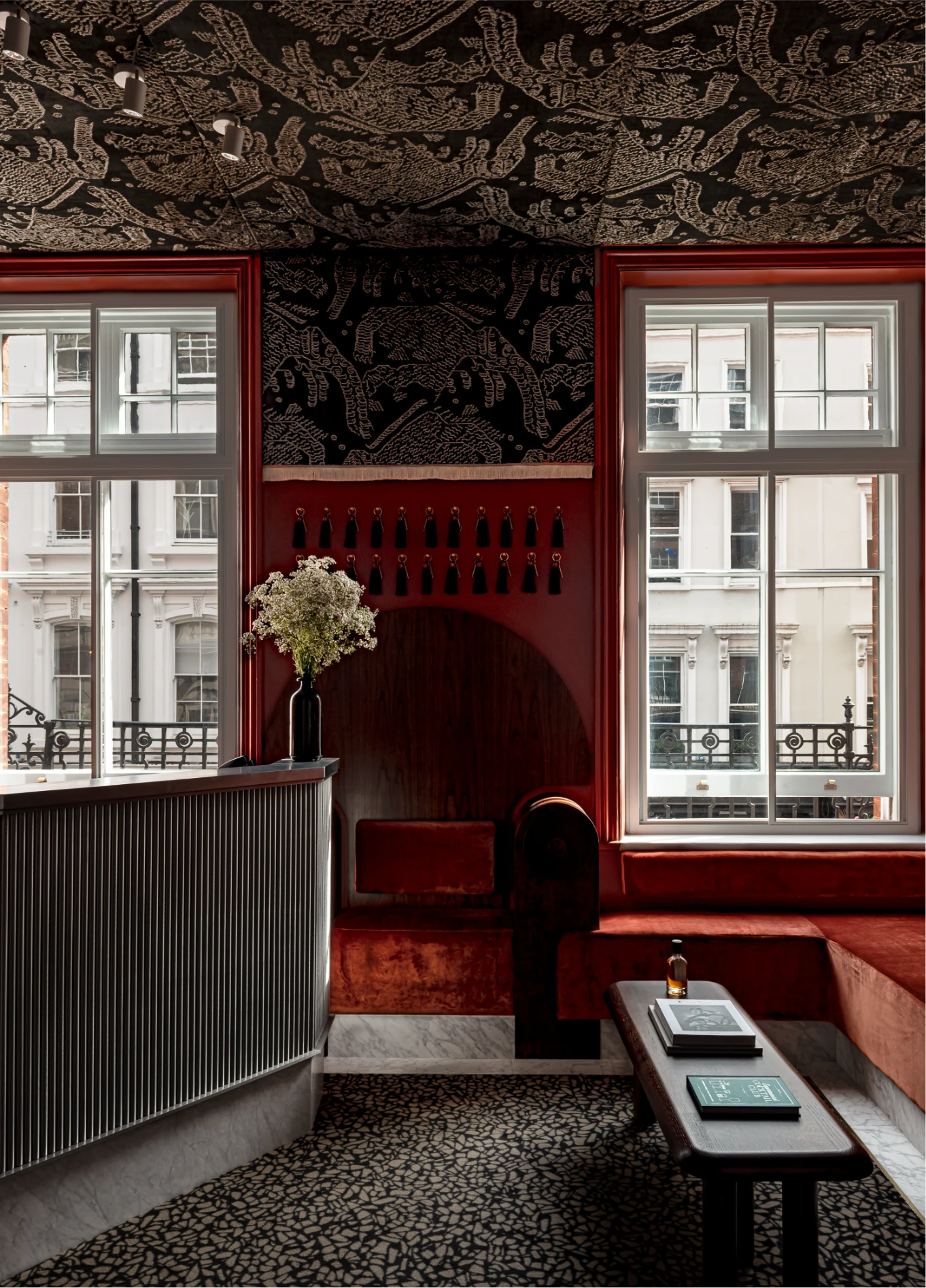 Hotel entrance with red floral decoration at Henrietta Experimental, Covent Garden, London