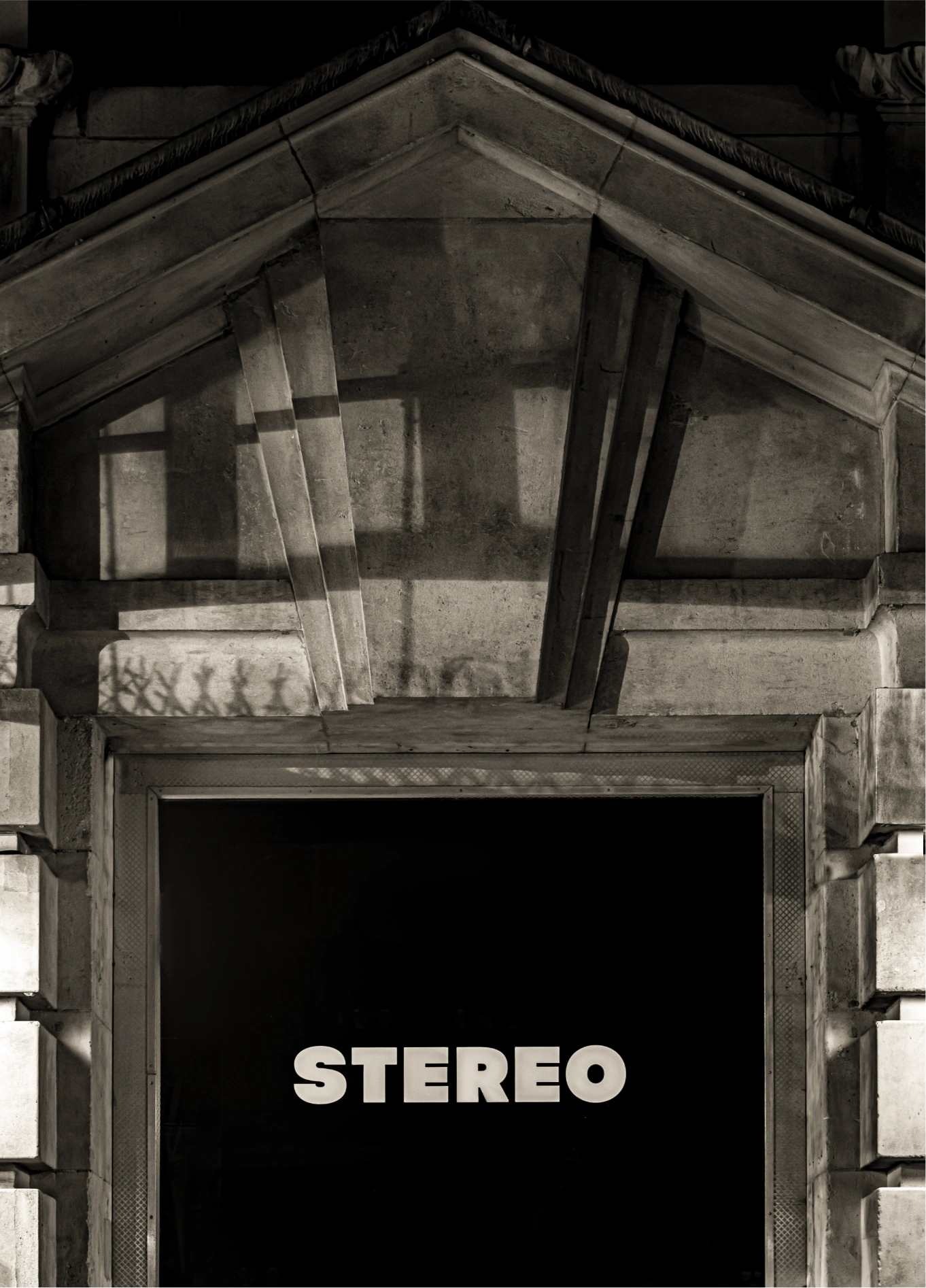 A glowing sign displaying the word "STEREO" above an entrance, in a sophisticated nightlife setting by the Experimental Group.