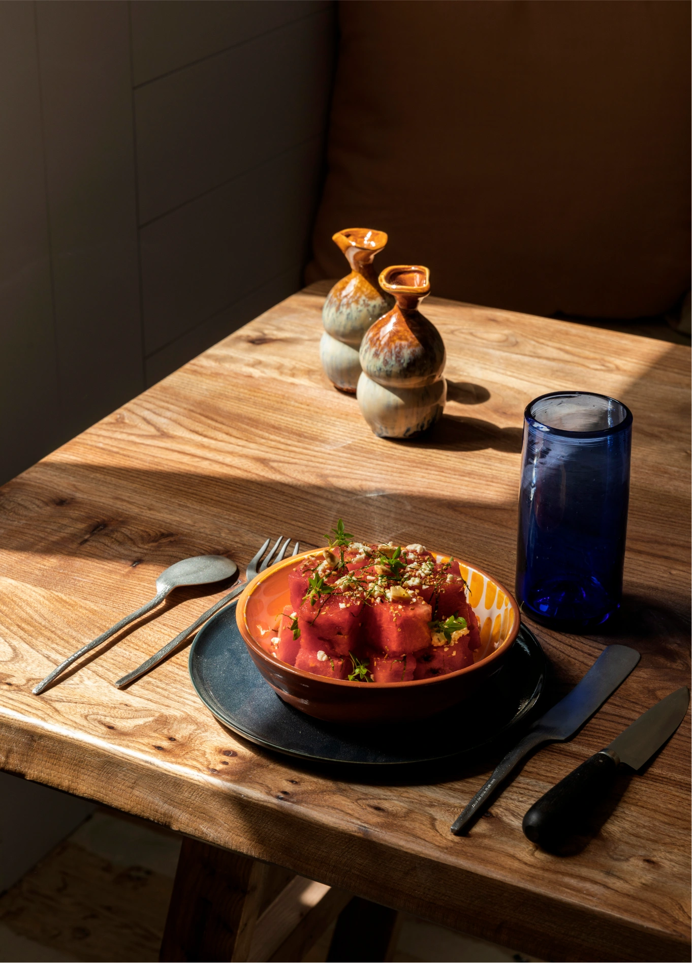 Close-up of a gourmet dish served in a colorful bowl on a rustic wooden table at Manorca Experimental.