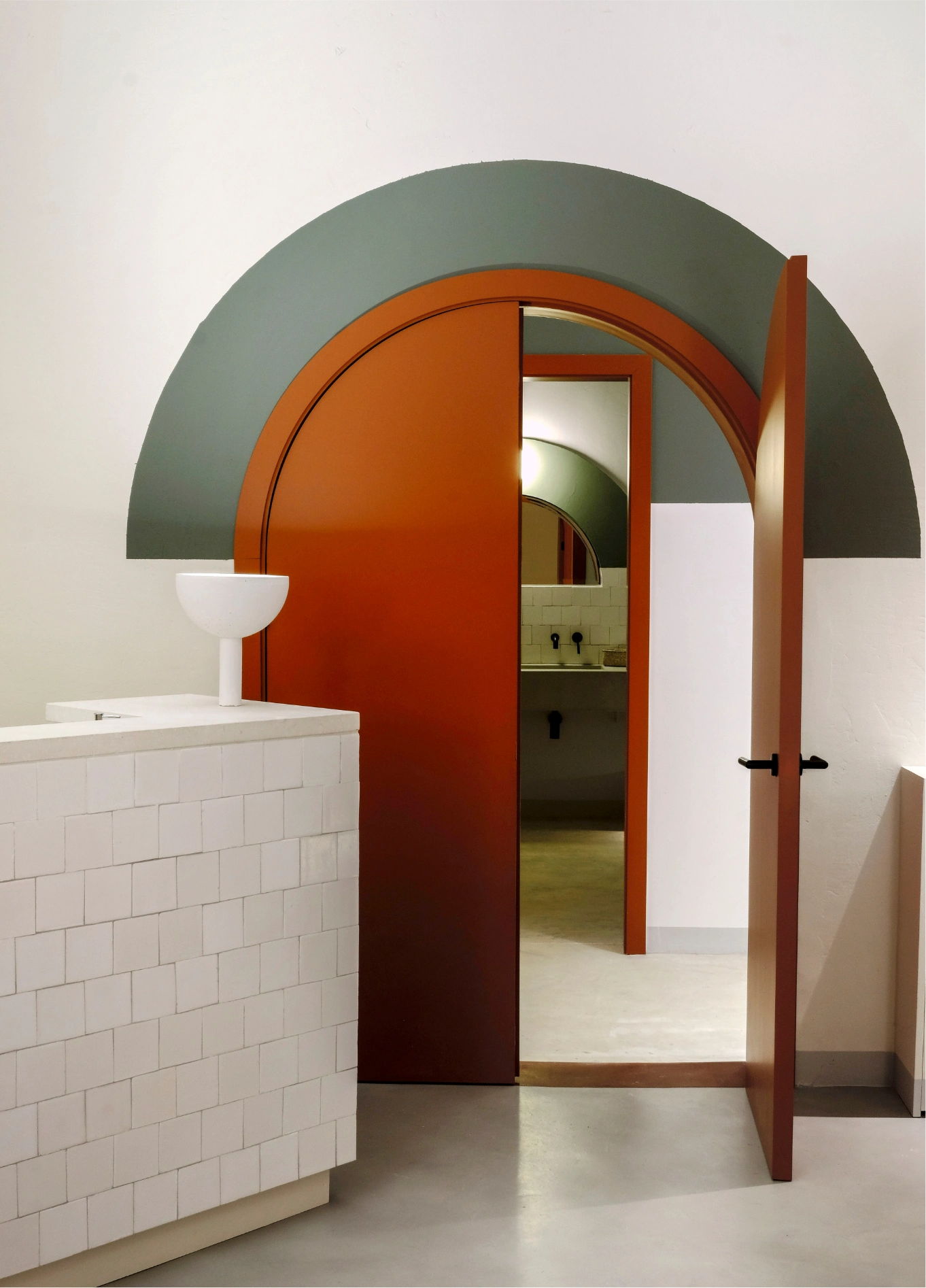 View of an elegant arched wooden door opening into a spa area, highlighting the interior architecture.