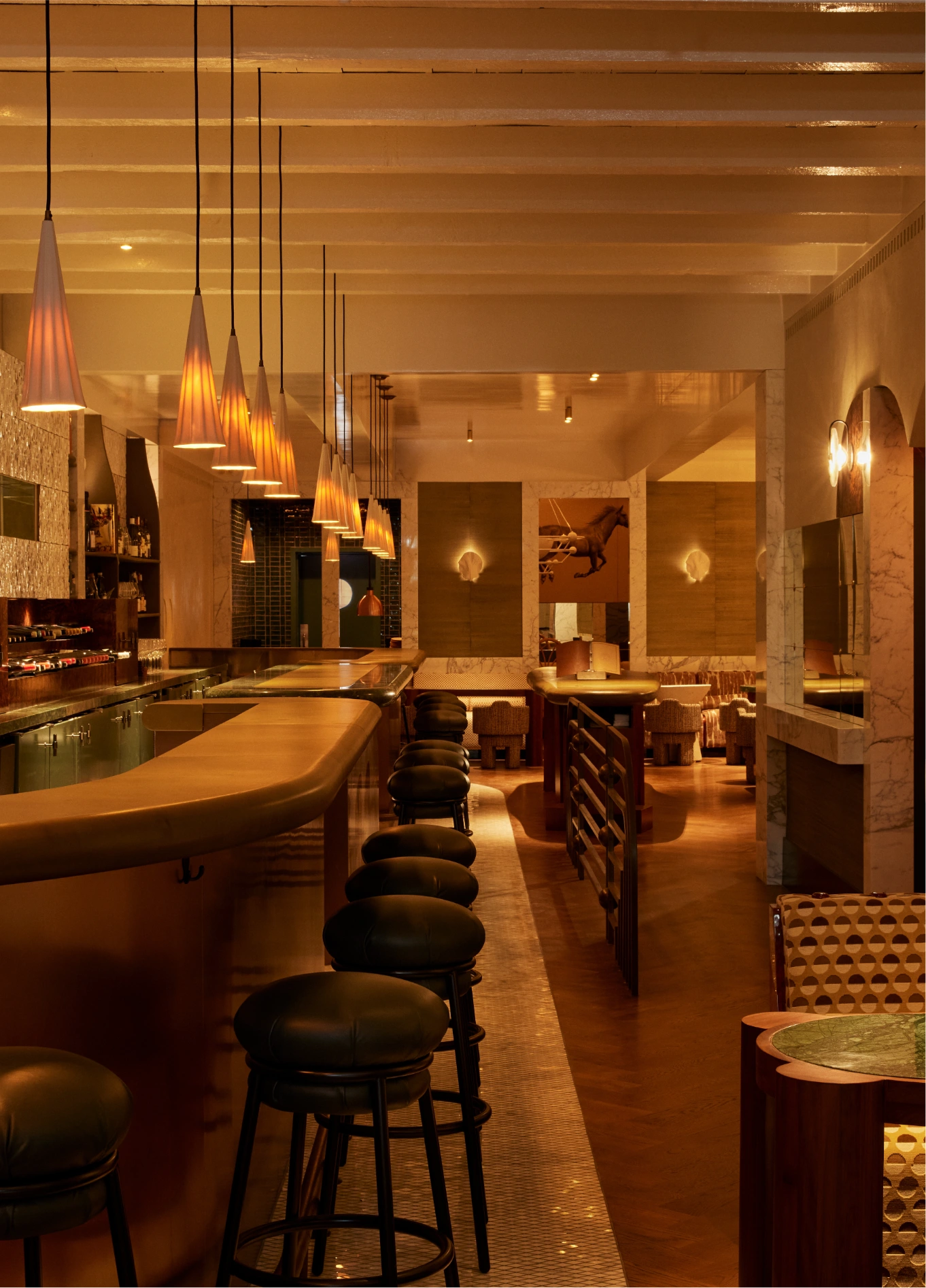 Cozy and elegant atmosphere of La Compagnie Wine Bar, highlighting the wooden counter and warm lighting.