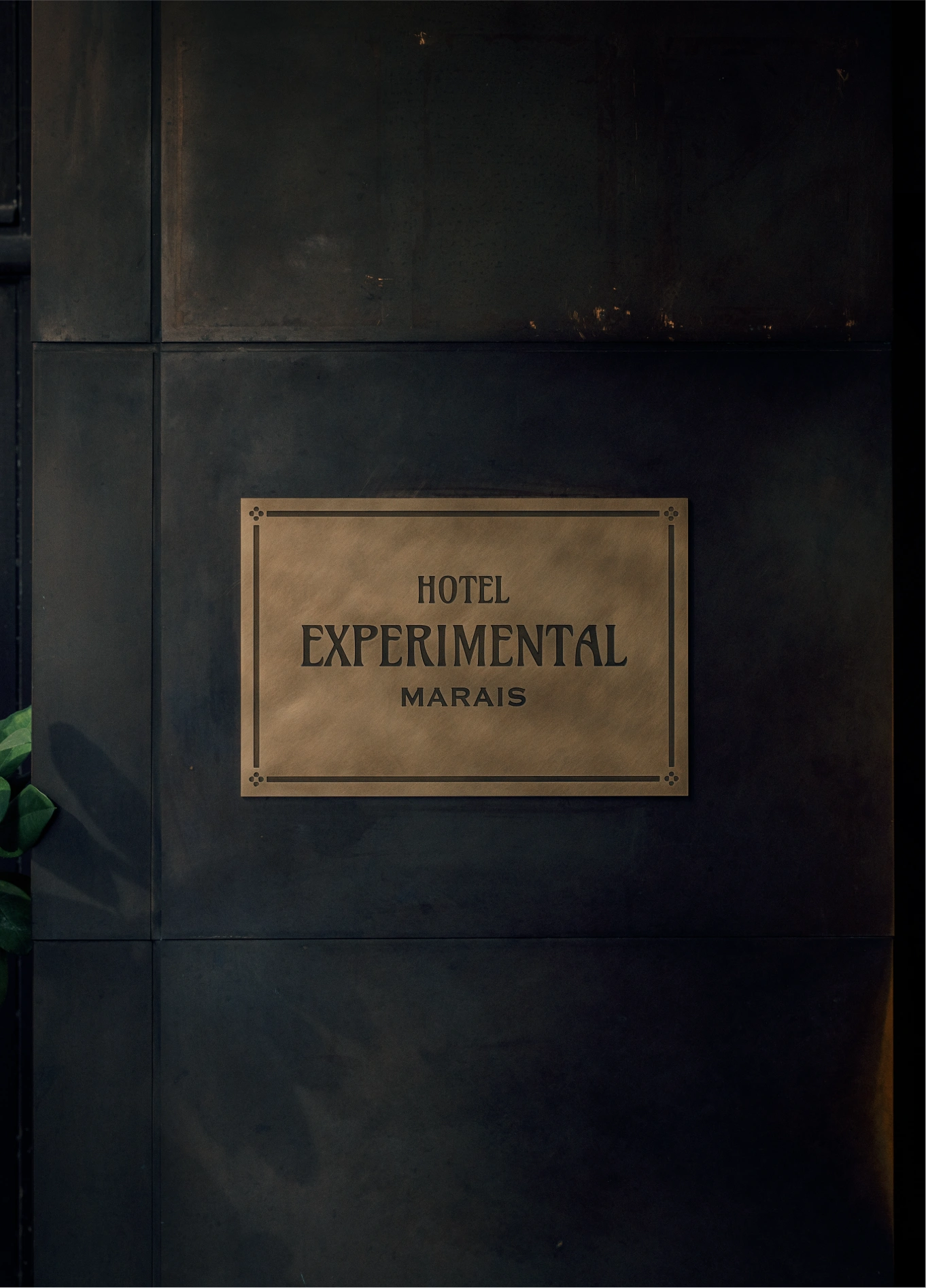Experimental Marais hotel sign on dark background, Paris