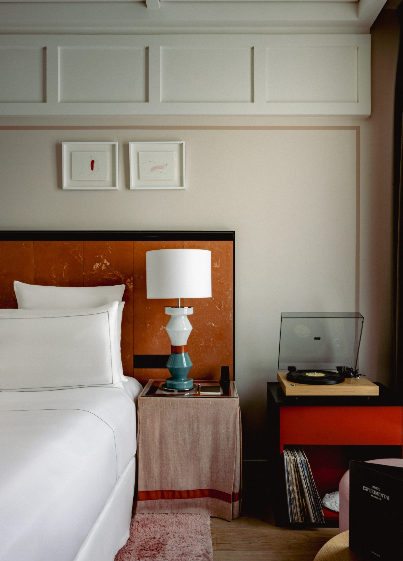 Bedroom with king size bed and vintage bedside lamp at Experimental Marais, Paris