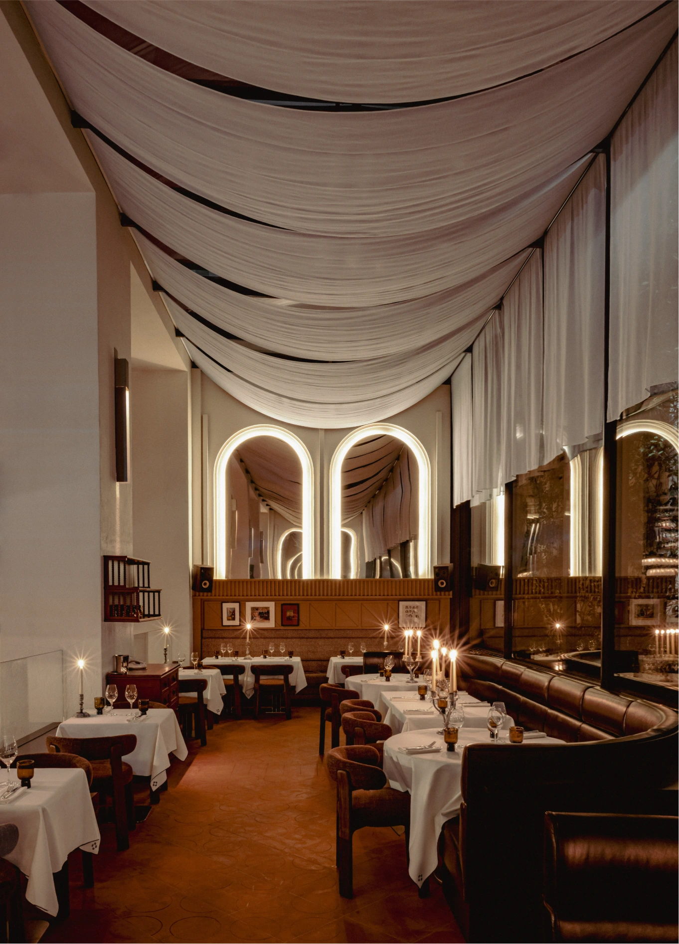 Long vaulted dining room with white tablecloths at Experimental Marais, Paris