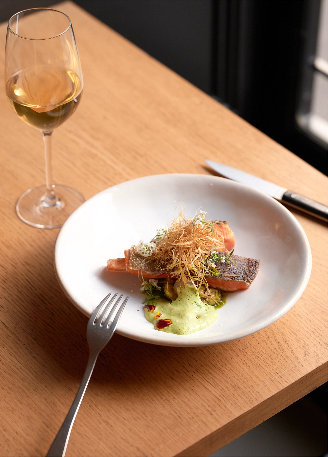Gourmet dish with white wine glass at Frenchie fine dining restaurant, Grand Pigalle, Paris 9