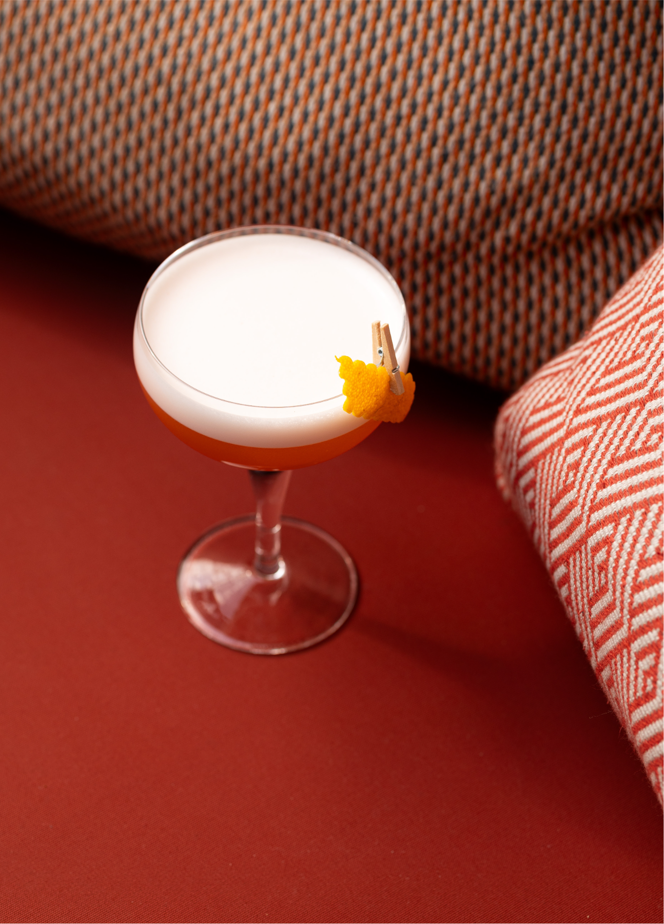 White cocktail coupe on red background at The Shed rooftop bar, Grands Boulevards, Paris