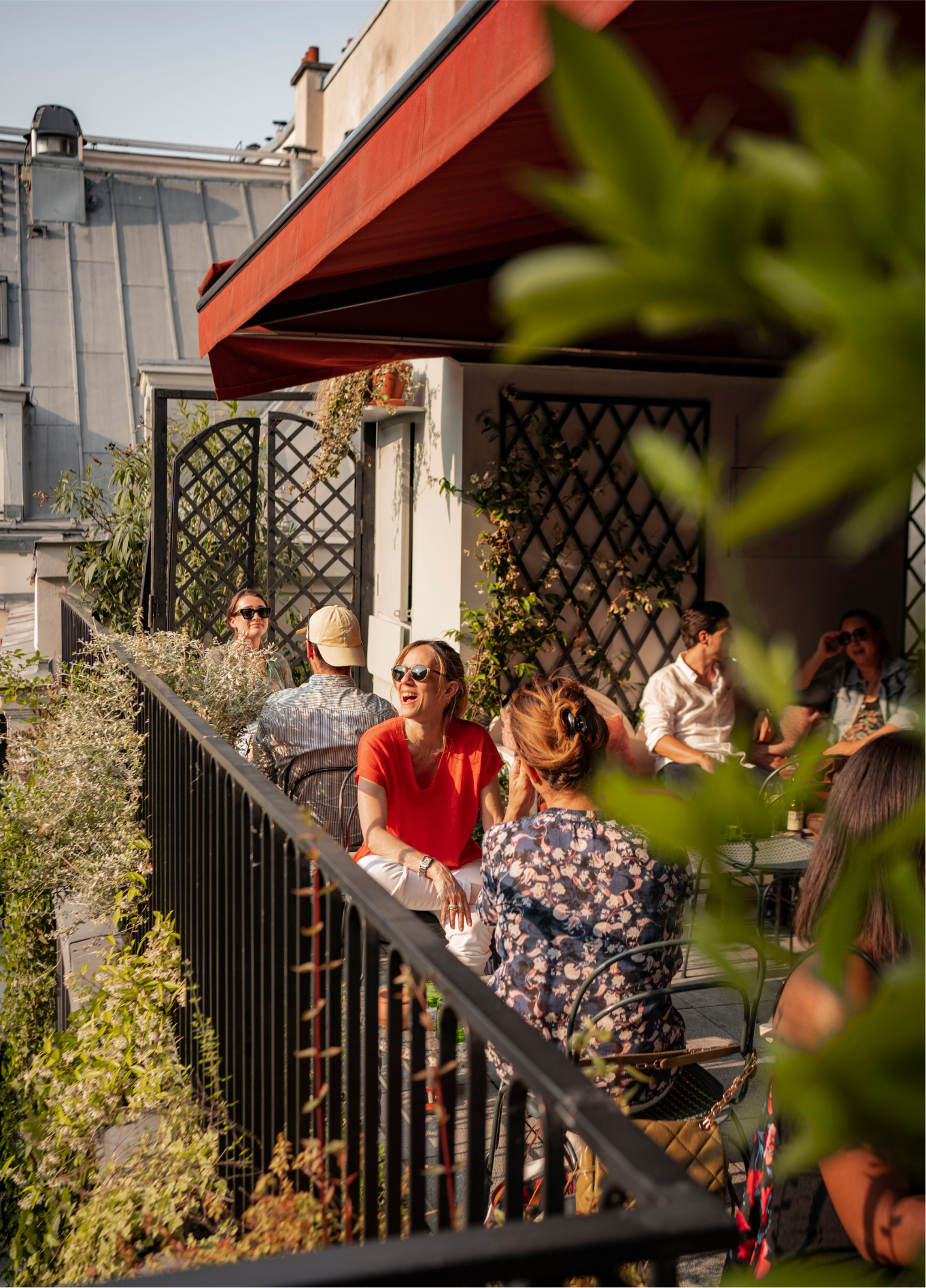 Group of guests dining on the green rooftop terrace at The Shed, Grands Boulevards, Paris 2