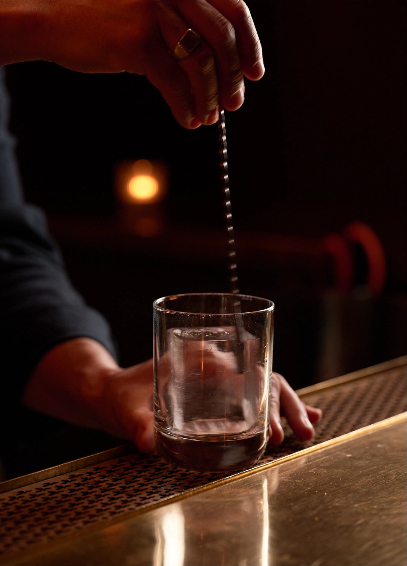 Bartender stirring a cocktail at L'Aigle d'Or cocktail bar, Val d'Isère