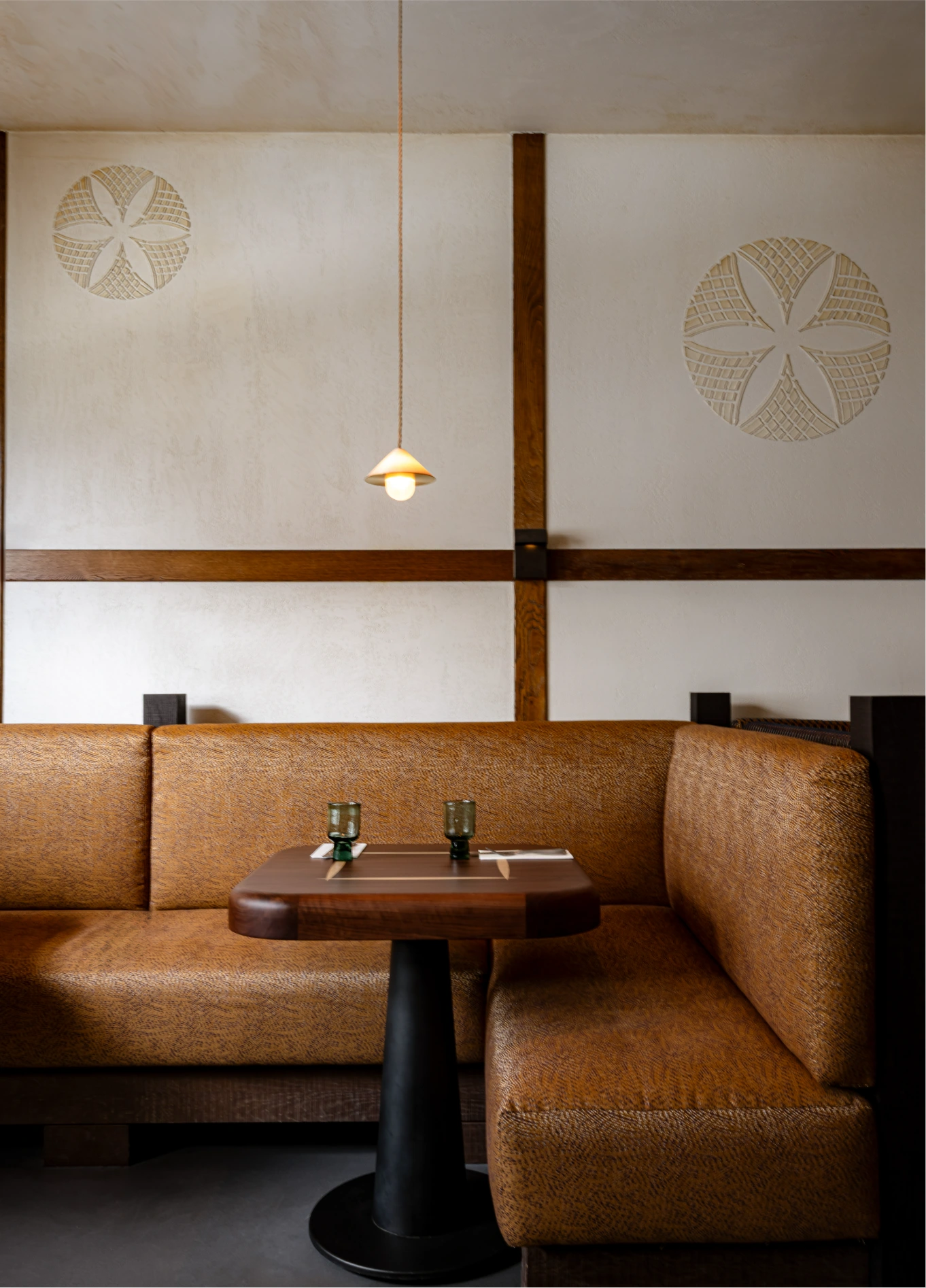 Intimate dining room with leather banquettes at L'Aiglon fine dining restaurant, Val d'Isère