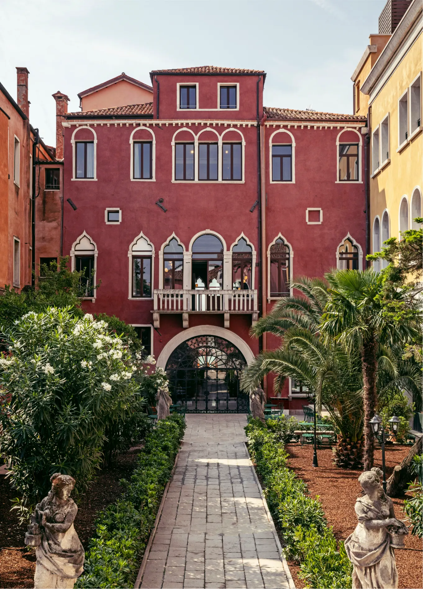 Pink exterior facade with garden at Il Palazzo Experimental boutique hotel, Venice