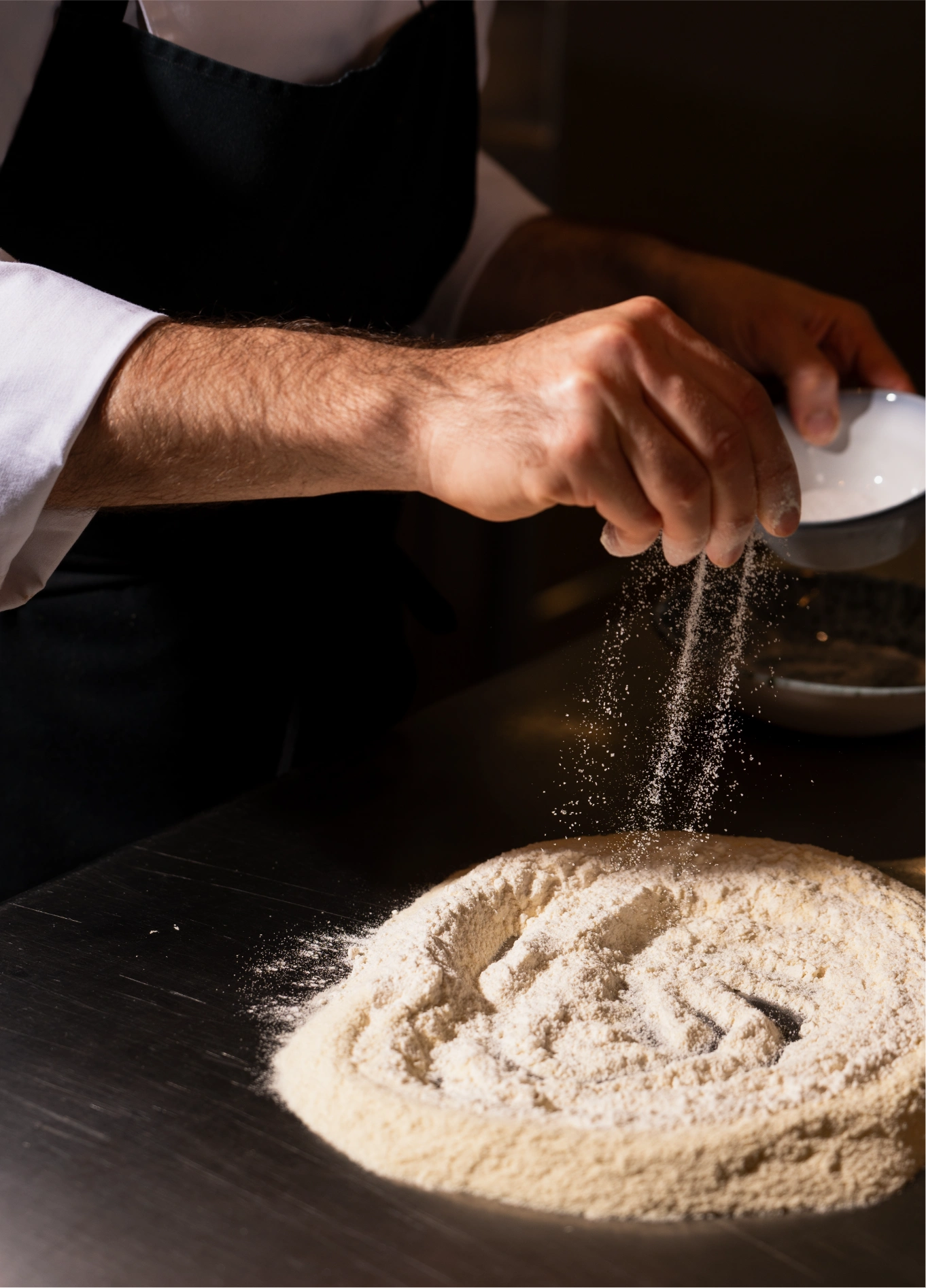 Chef dusting flour on dough at Adriatica Italian restaurant, Venice