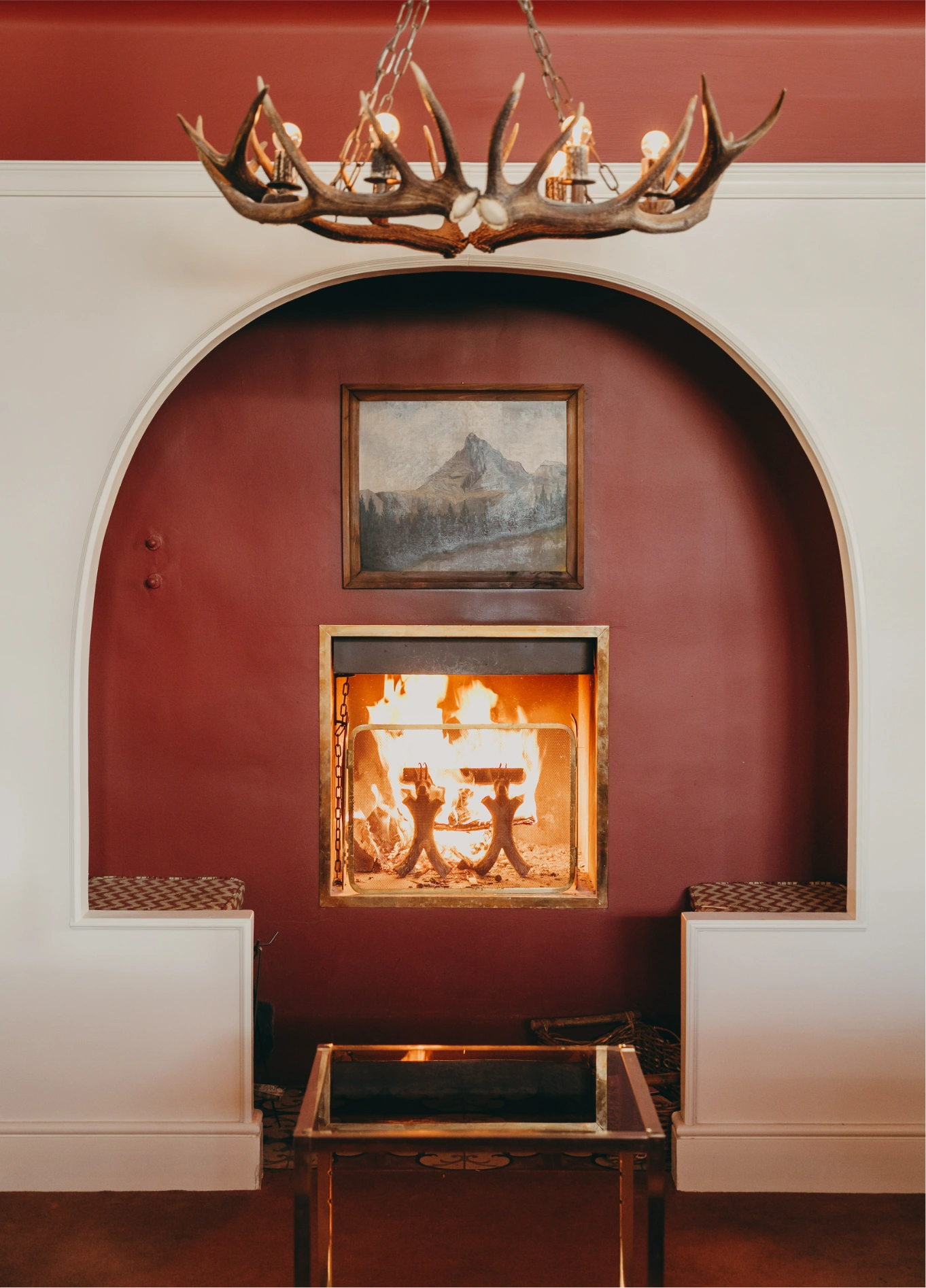 Cosy fireplace in red alcove at Experimental Chalet, Verbier, Swiss Alps