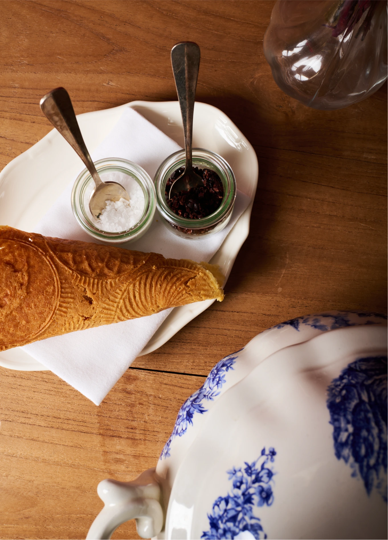 Brioche, jam, coffee and blue patterned crockery on rustic wooden table at St Bernard restaurant, Verbier, Swiss Alps