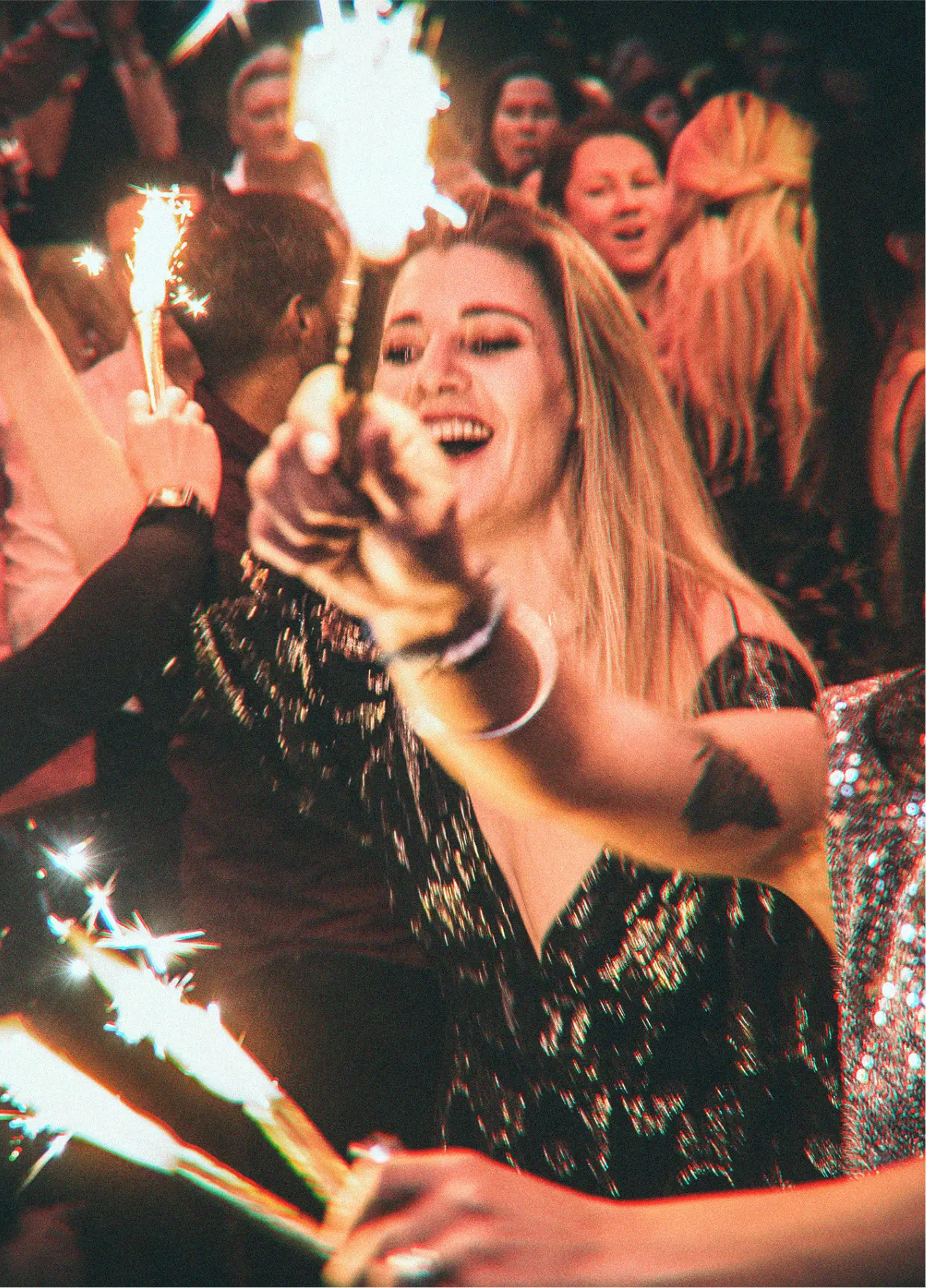 Woman holding sparklers at Farm Club night club, Verbier, Swiss Alps