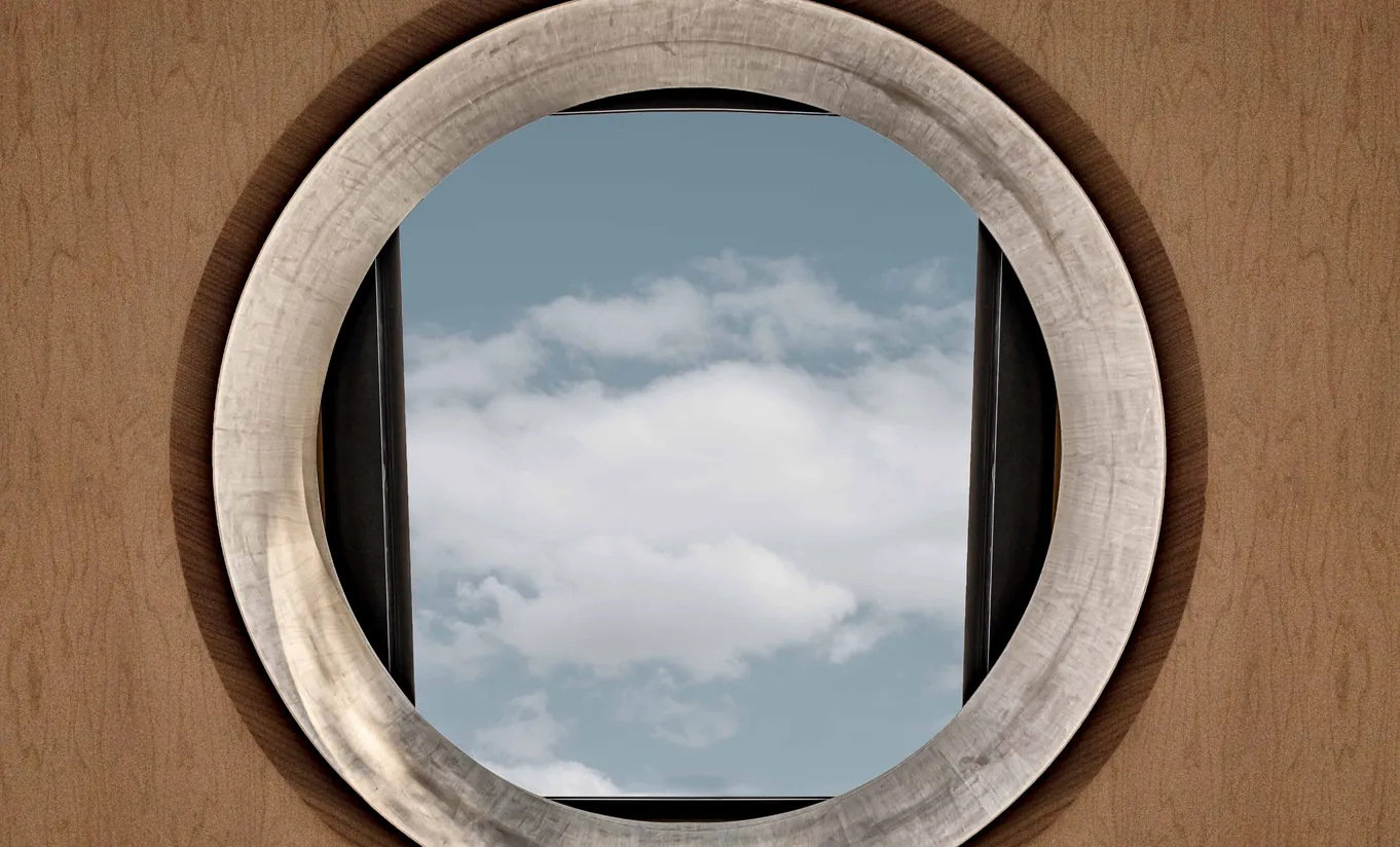 Round porthole window with a view of the sky and countryside in the Grand Cowley Manor Suite at Cowley Manor Experimental, Cotswolds