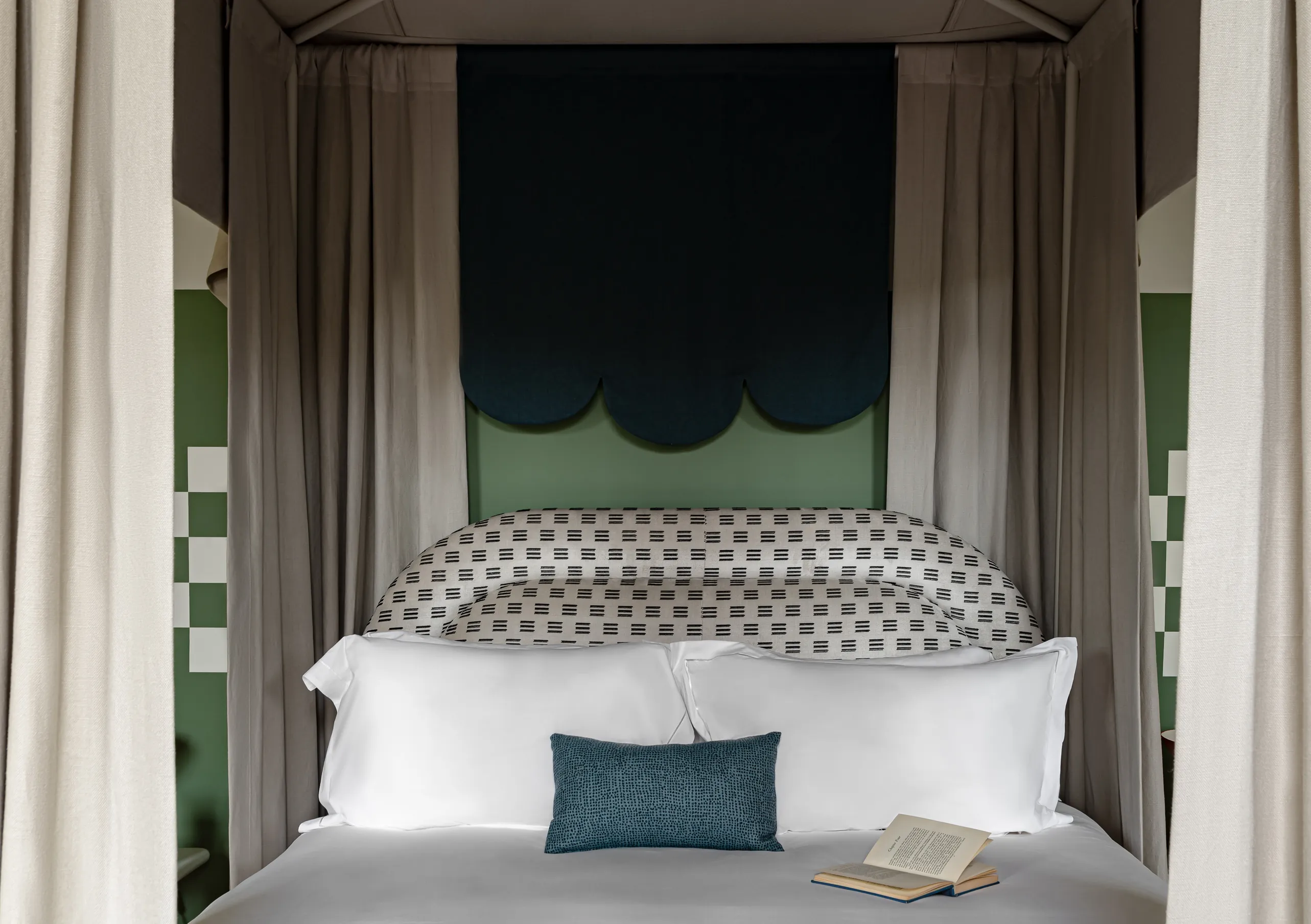 Bedroom with a four-poster bed, sage green canopy and patterned headboard in the St Mary Suite at Cowley Manor Experimental, a luxury hotel in the Cotswolds