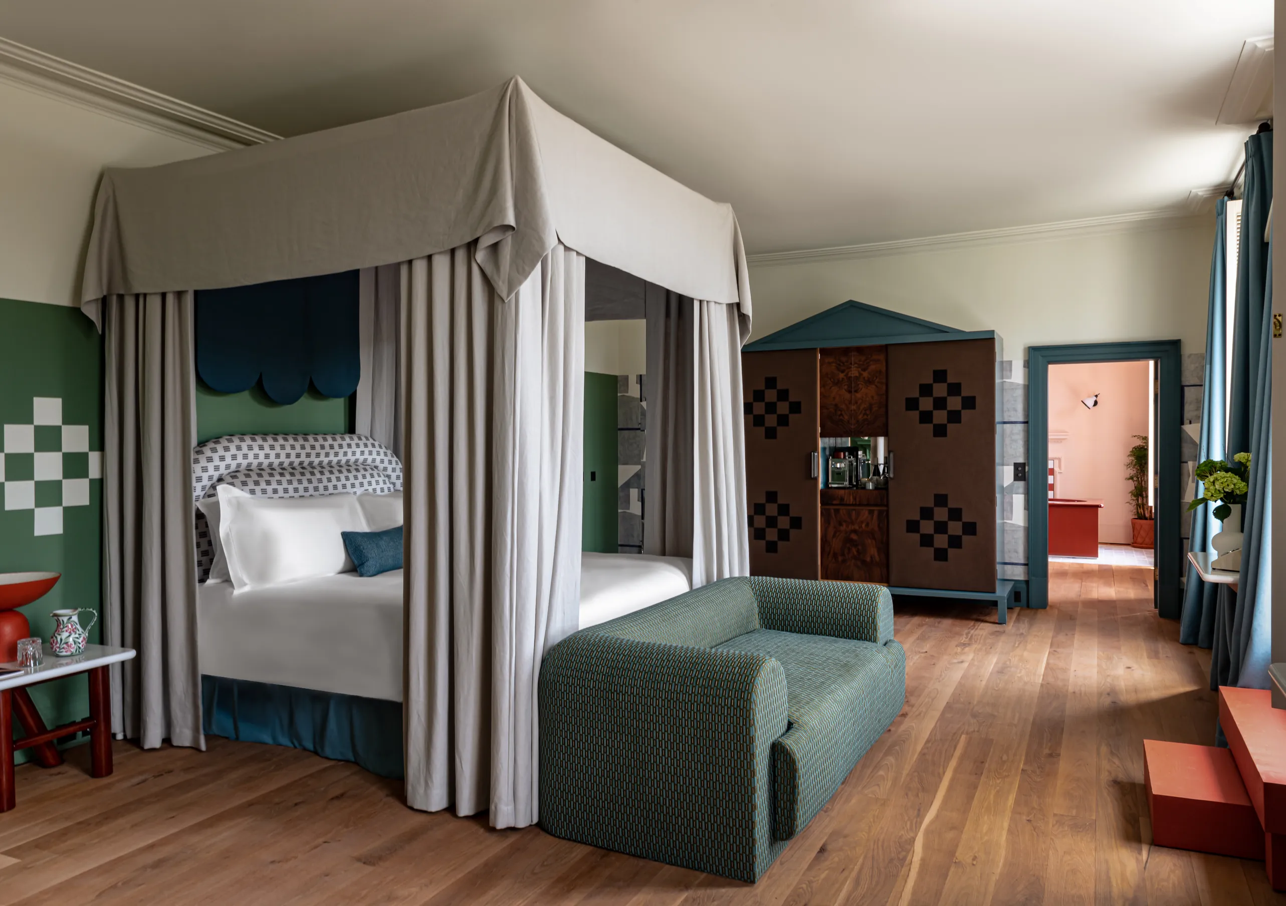 Bedroom with a four-poster bed and wooden floors in the Cowley Manor Suite at Cowley Manor Experimental, a luxury spa hotel in the Cotswolds