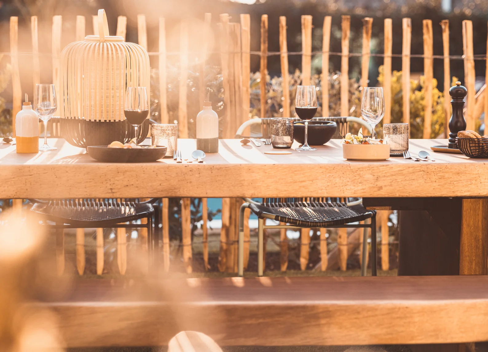 Outdoor terrace with wooden table and convivial atmosphere by Experimental Group