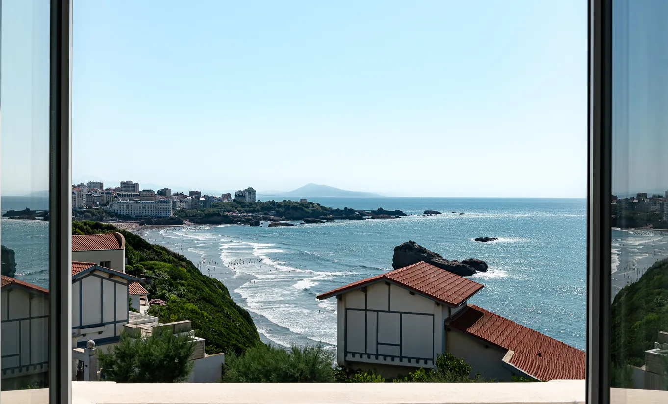 Regina Experimental Biarritz hotel panoramic window view over the Grande Plage beach, Atlantic Ocean, and Biarritz rocky coastline