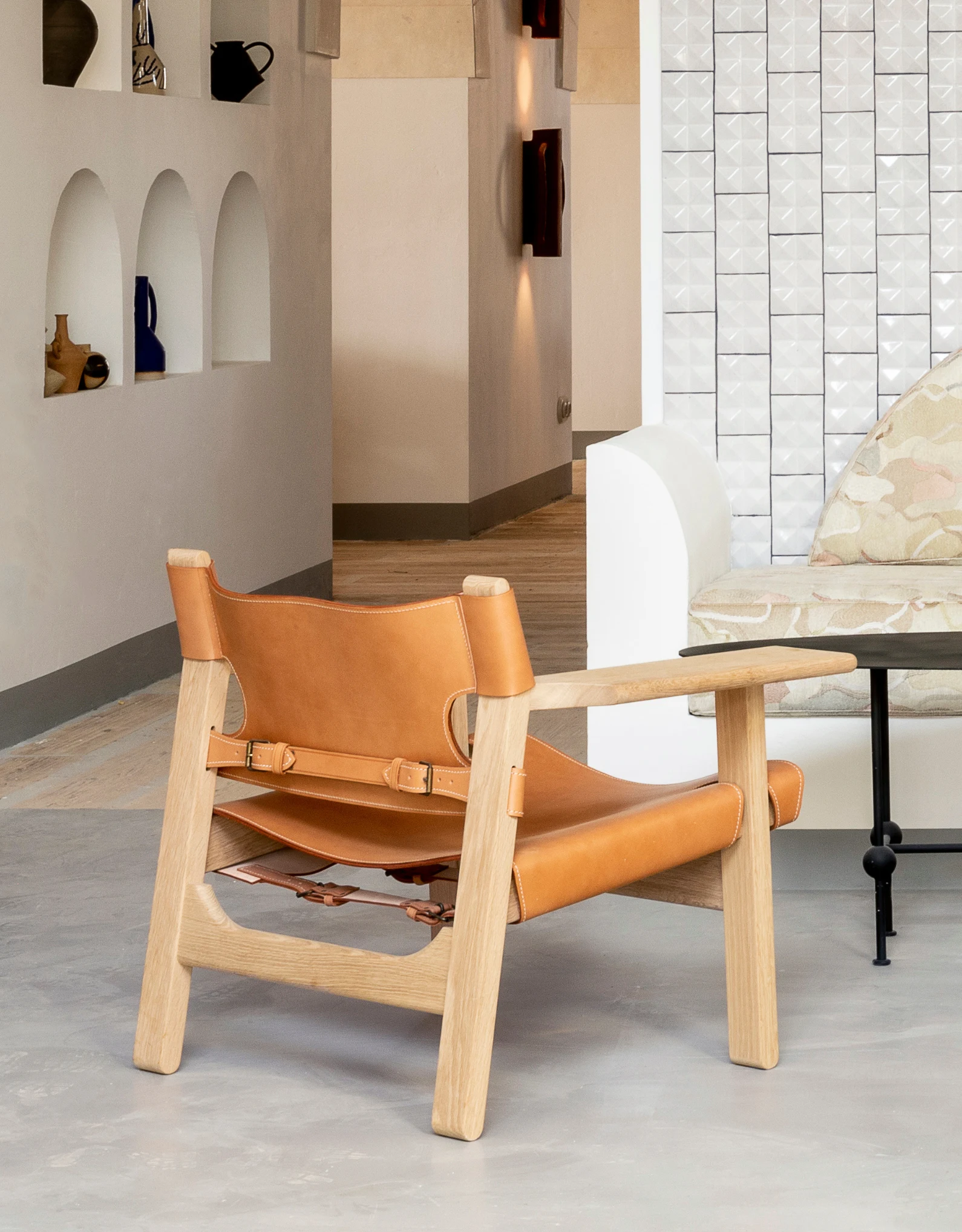Designer armchair in an elegant and bright lounge, showcasing the attention to interior design by the Experimental Group.