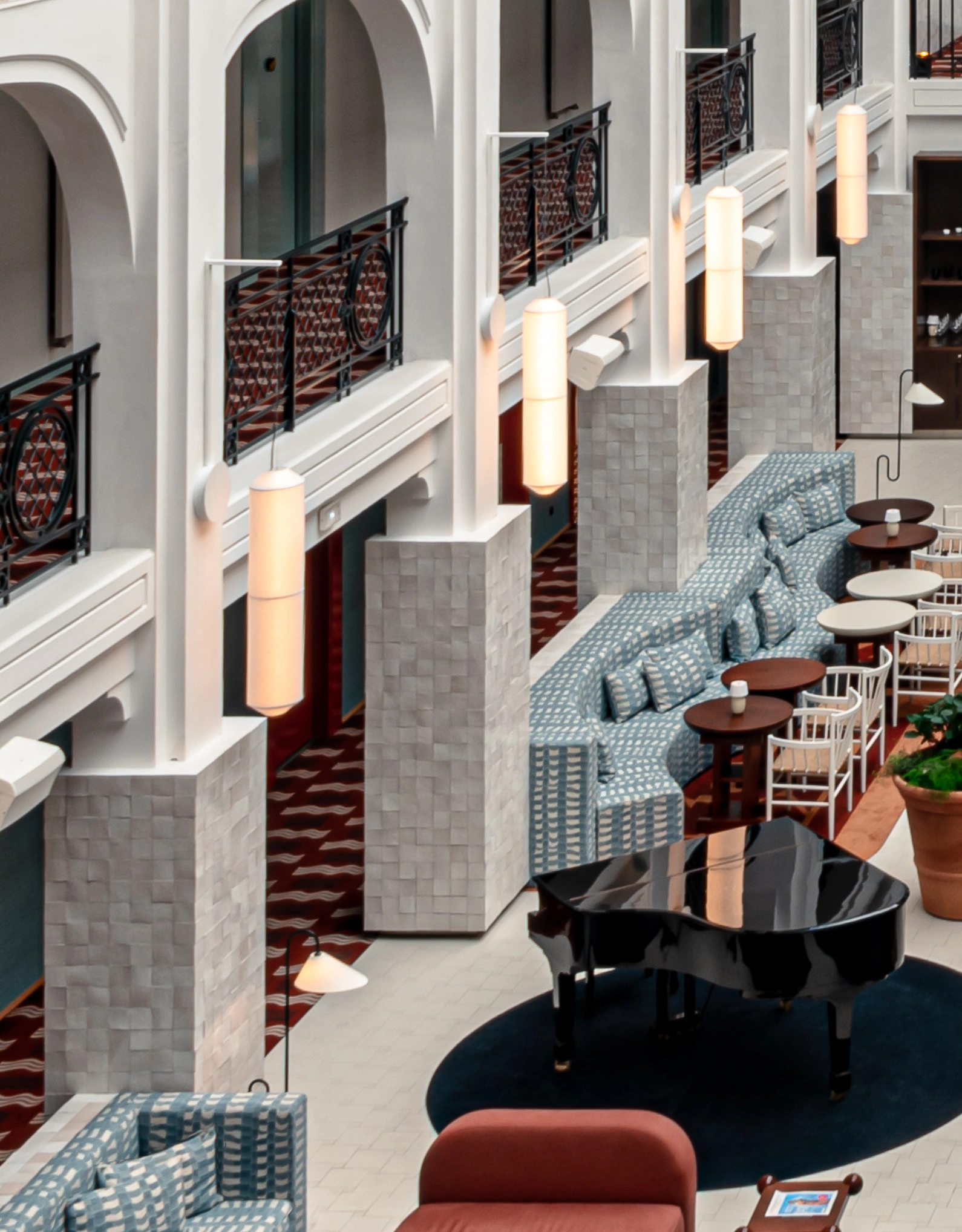 View of the central hall with its arches and cozy atmosphere, characteristic of Experimental Group hotels.