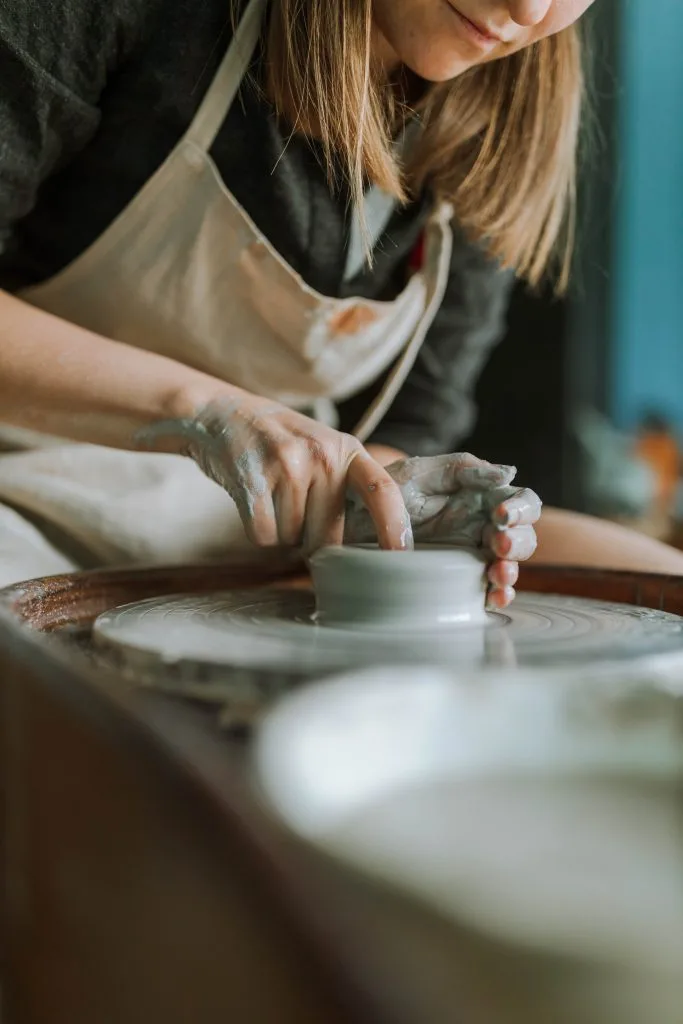Chef plating a dish in a professional kitchen setting