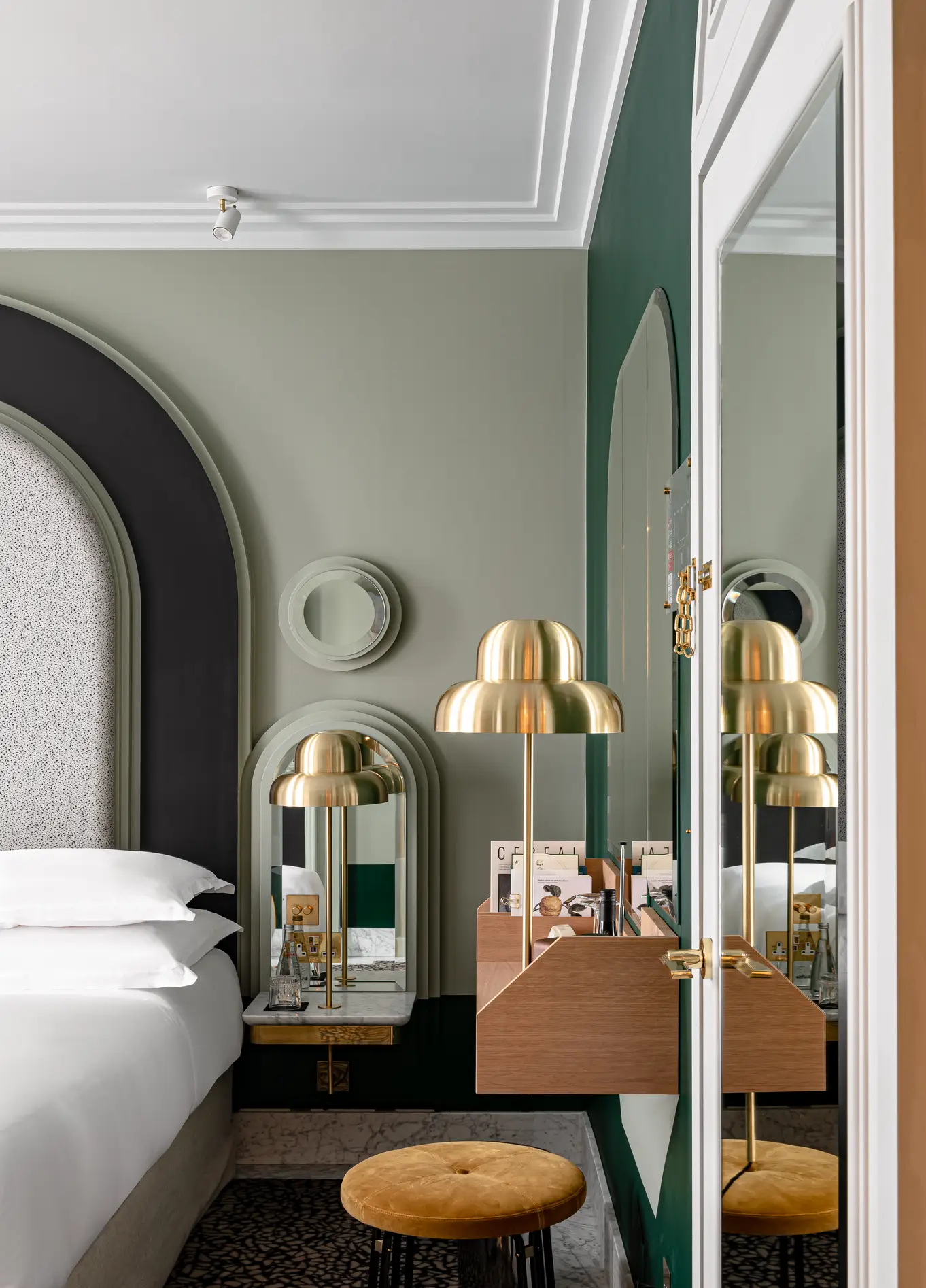 Chambre avec tête de lit vert foncé et miroirs dorés à l'Henrietta Experimental, Covent Garden, Londres