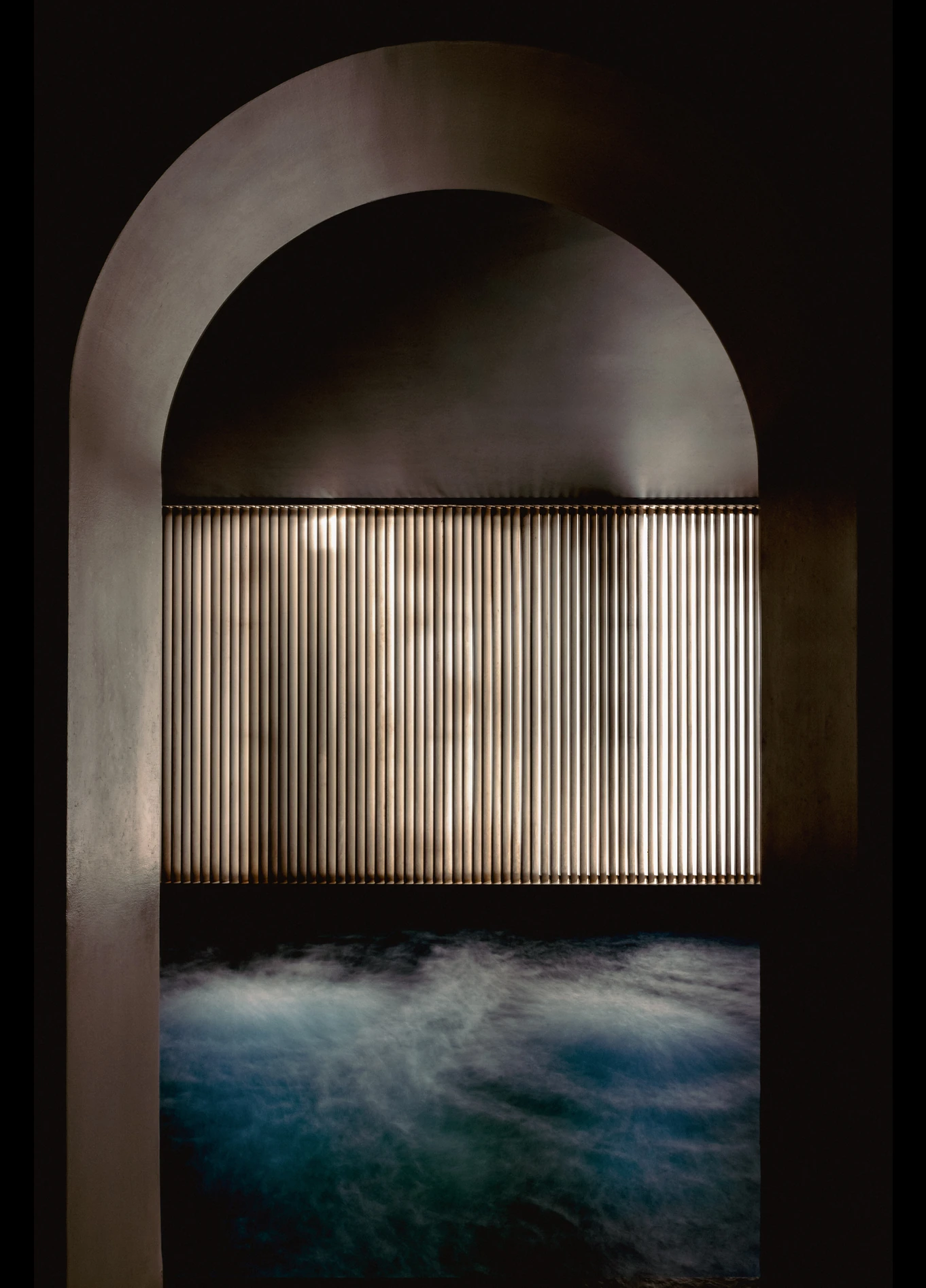 Arched indoor swimming pool with blue lighting at Spa by Experimental, Marais, Paris