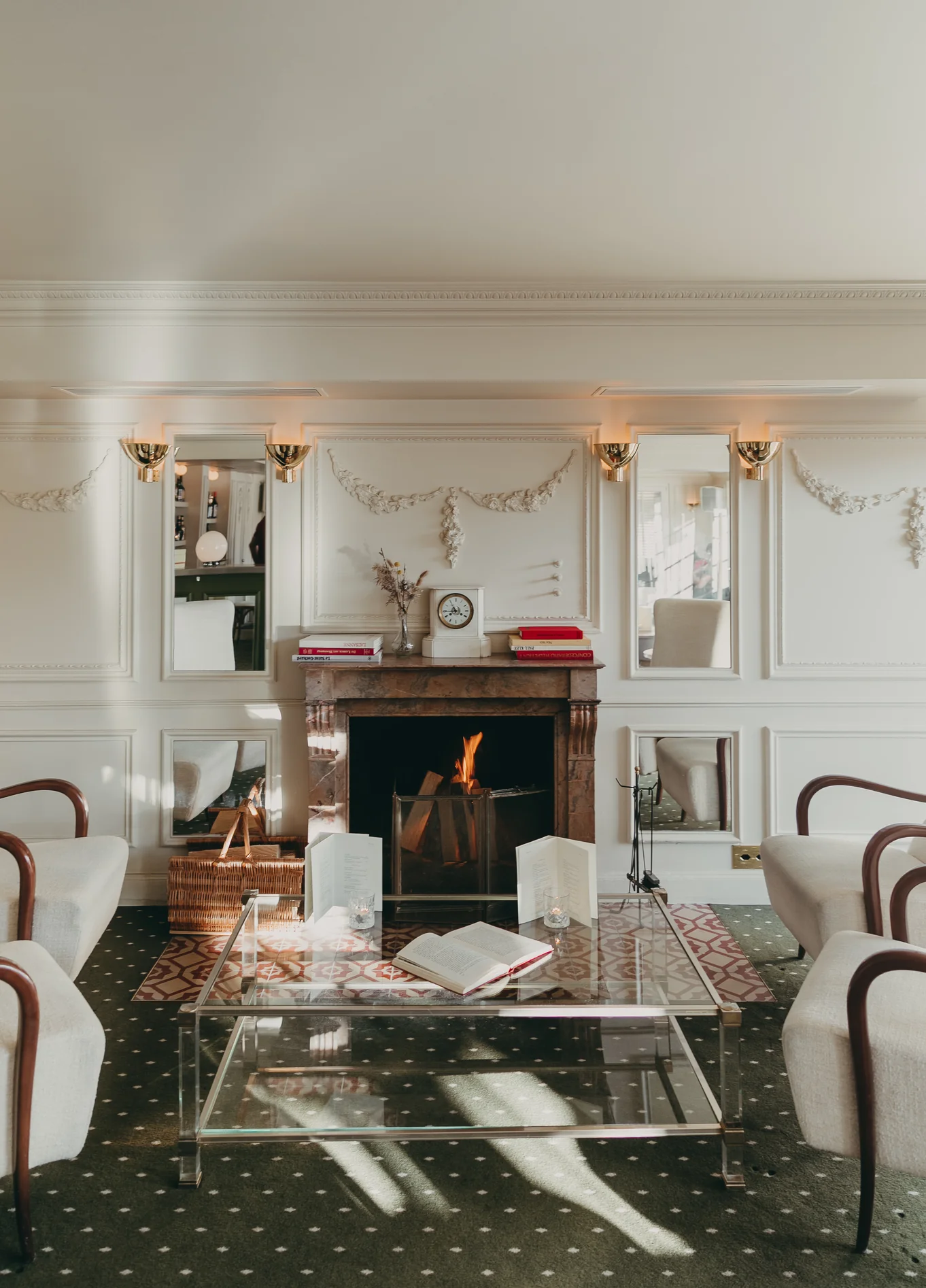 Cosy lounge with fireplace and white sofas at Experimental Cocktail Club, Verbier, Swiss Alps