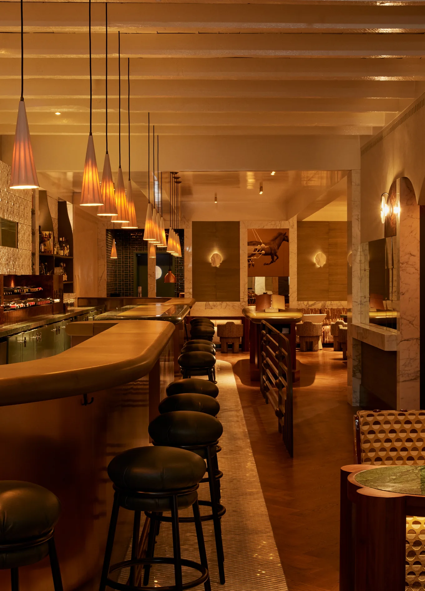 Cozy and elegant atmosphere of La Compagnie Wine Bar, highlighting the wooden counter and warm lighting.