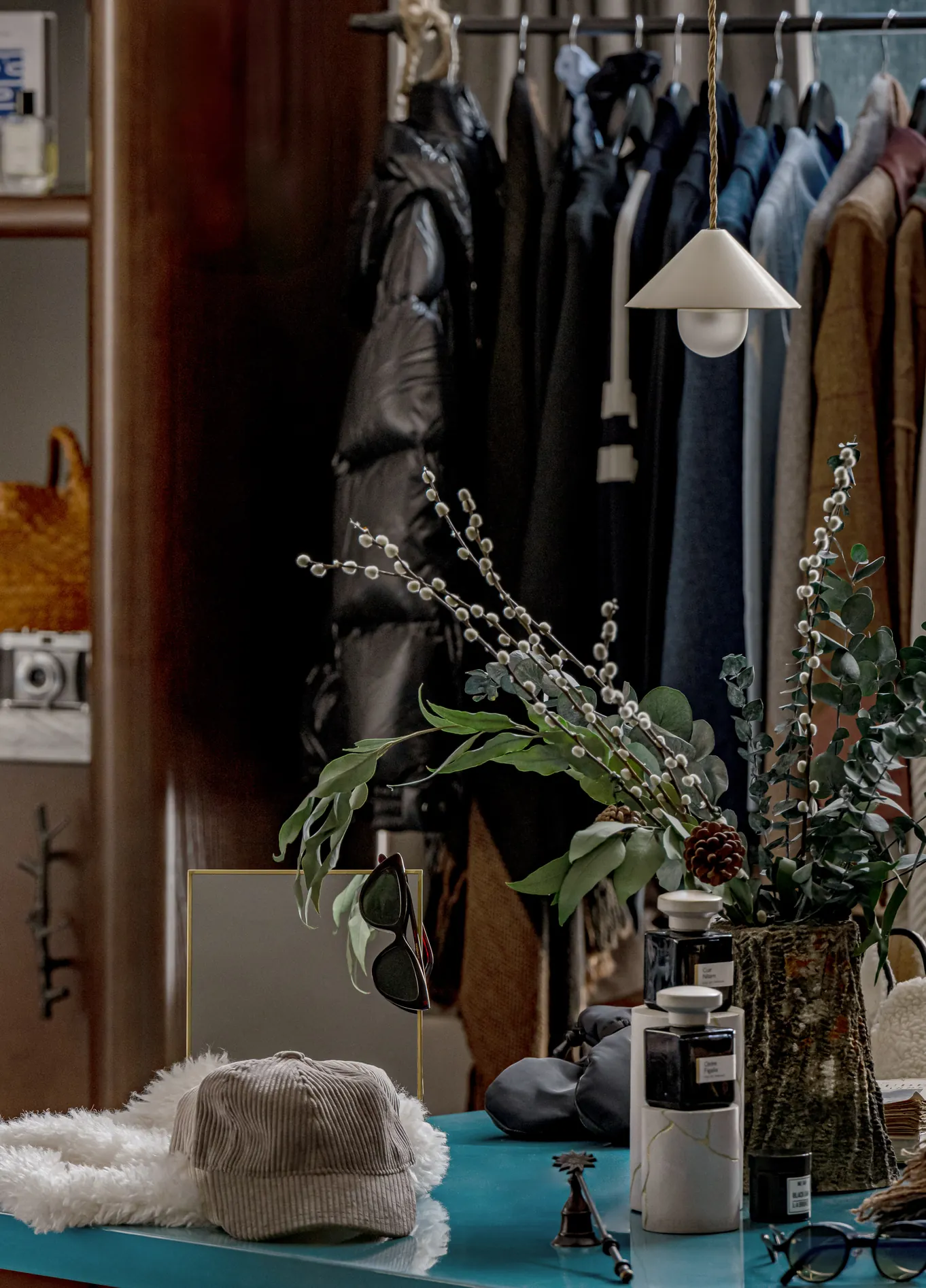 Clothing rack with plants and accessories at Experimental Chalet boutique, Val d'Isère