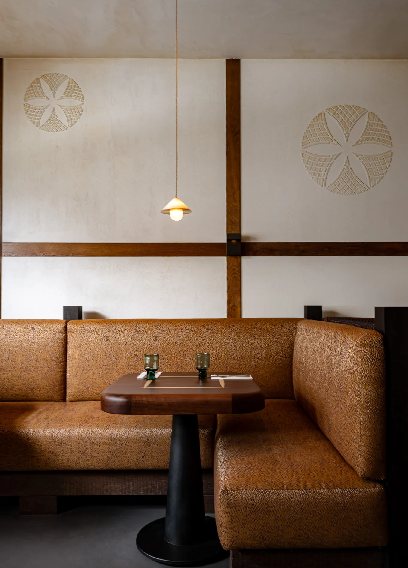 Intimate dining room with leather banquettes at L'Aiglon fine dining restaurant, Val d'Isère
